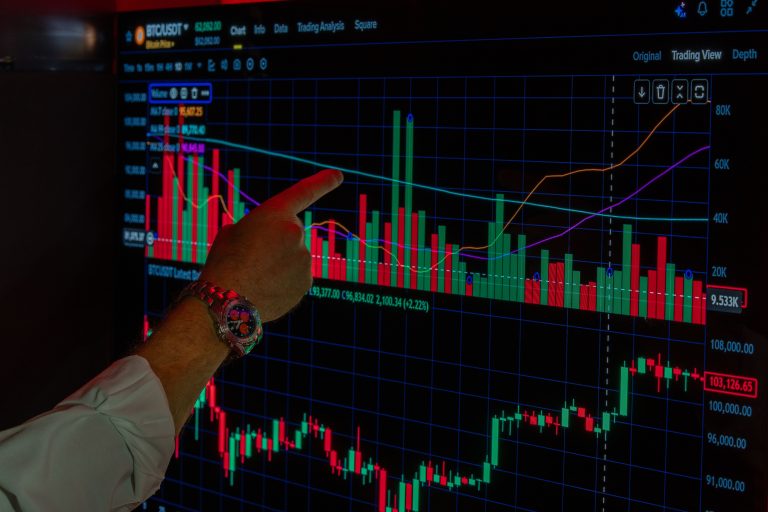 Close-up of a person analyzing Bitcoin market trends on a digital trading platform screen