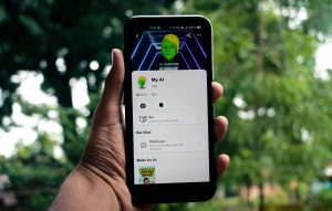 A person holds a smartphone displaying an AI application in a green outdoor setting