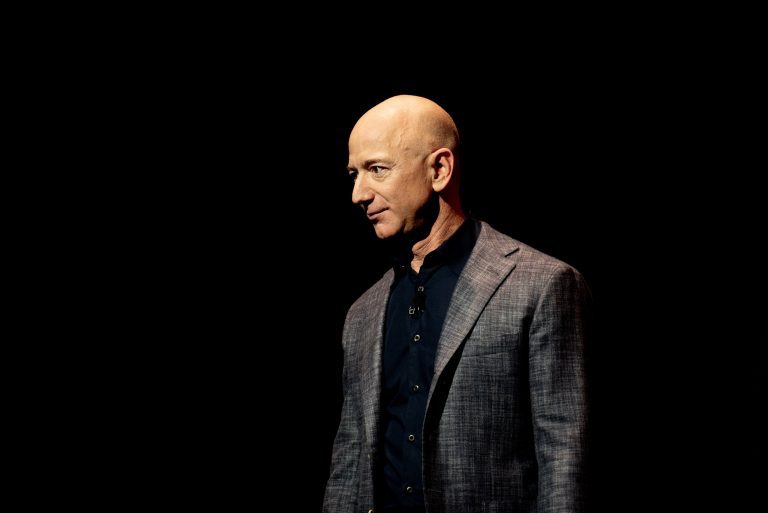 Jeff Bezos speaks on stage during a Blue Origin presentation